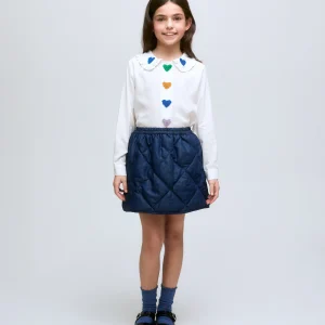 Falda corta de niña en denim acolchado con cintura elástica.